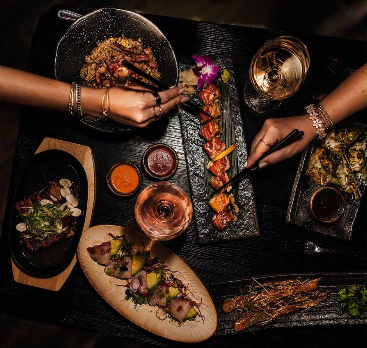 An overhead spread of Yamasaki sushi, small plates and wine