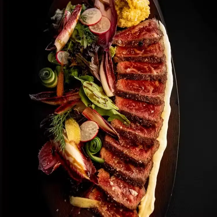 Sliced prime steak with seasonal greens