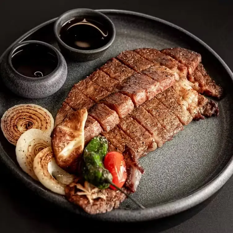 Sliced wagyu with charred onion and dipping sauces